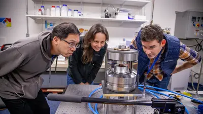 Laboratory Engineer Javier Rojas uses a plate of copper to test the recently acquired Paris-Edinburg press, which will allow researchers to simultaneously study seismic and electrical properties of rocks under high temperatures and pressures