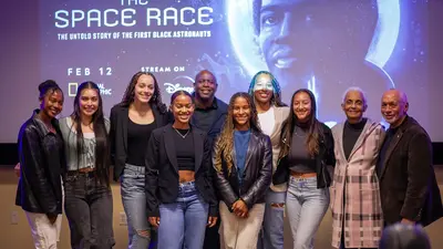 Members of the Howard University women's soccer team pose with former astronaut Leland Melvin and former NASA Administrator Charles Bolden