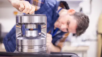 Javier places a copper sample in the press