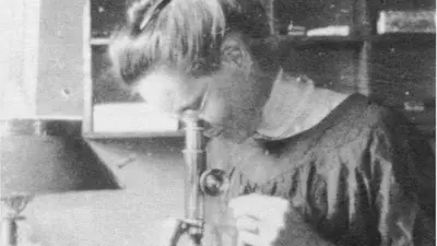 Nettie Marie Stevens is shown here looking through a microscope while studying at the Stazione Zoologica in Naples, Italy. 