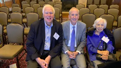 Richard Meserve, Eric Isaacs, and Maxine Singer at a book signing event for Robert Hazen