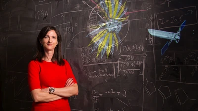 Sarah Seager in front of a blackboard. Photo by Sam Ogden
