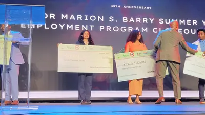 Veronica Duran poses on stage with her 20K check for the Mayor's Opportunity Scholarship