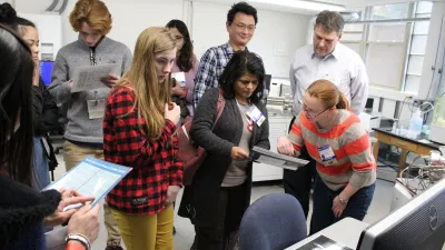 Timothy Mock gives a tour of the Mass Spectrometry lab to high school students from the 2019 American Junior Academy of Science conference.