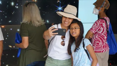 Visitors take a selfie in front of the VizLab at the Carnegie Observatories Open House, 2022
