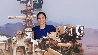 Anushree Srivastava poses with Mars rover mock ups