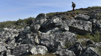 A researcher conducting fieldwork at the Slave Craton, Canada