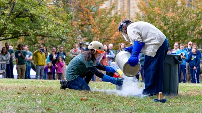 Diana Roman and Andrea Goltz prepare a "trash-cano" at the Earth & Planets Laboratory Open House.