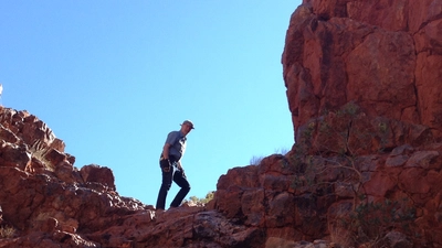 Bob Hazen hiking in the field.