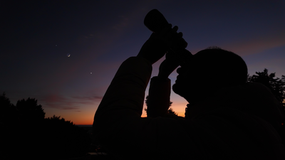 Stargazing with binoculars at sunset