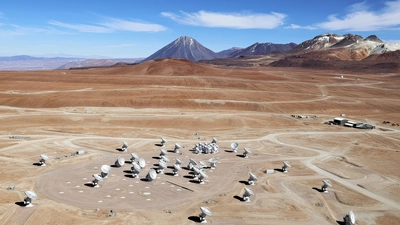 This image shows an aerial view of the Chajnantor Plateau, located at an altitude of 5000 meters in the Chilean Andes, where the array of ALMA antennas is located. 