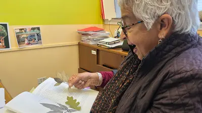 Devaki Bhaya looks at book from her Party With Trees class. Courtesy: Carnegie Science.