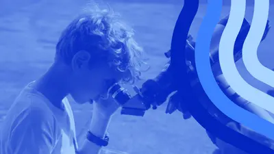 Observatories Open House boy looks into solar telescope with blue visual styling elements