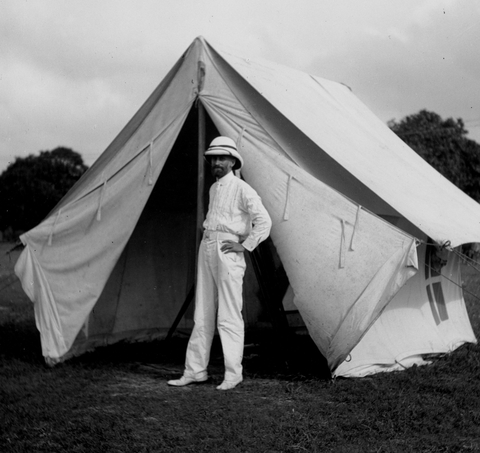 Carnegie investigator Louis Bauer stands outside a tent during field work pertaining to terrestrial magnetism in Colombo, Ceylon.
