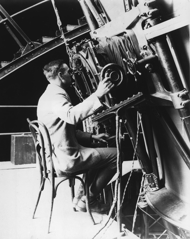 Edwin Powell Hubble seated at the 100-inch reflecting telescope, Mount Wilson Observatory.