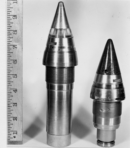 A proximity fuze at the left compared with a clockwork fuze at right.