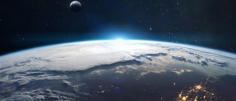 Earth seen from space with human settlements visible and the Moon in the background. Image purchased from Shutterstock.