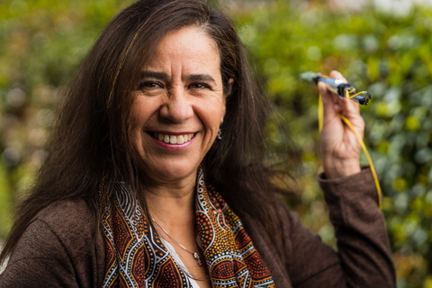 Solange Ramirez poses with an SDSS-V robot