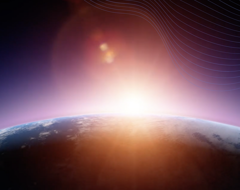 A star rises behind a planet, illuminating the planet's atmosphere.