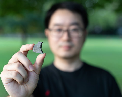 Peng Ni Hold Meteorite