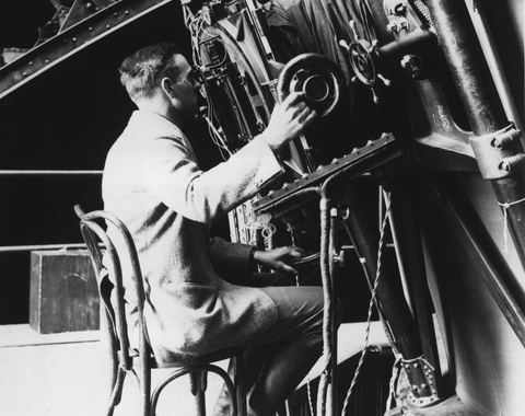 Edwin Powell Hubble seated at the 100-inch reflecting telescope, Mount Wilson Observatory.