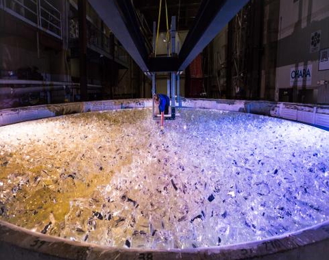 Mirror lab staff member places the last piece of glass into the mold for the fifth Giant Magellan Telescope mirror