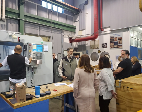 A tour group visits the Observatories machine shop