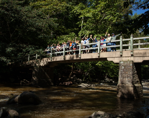 Postdocs and scientists cheer on Rapids Bridge in Rock Creek Park during Postdoc Appreciation Day