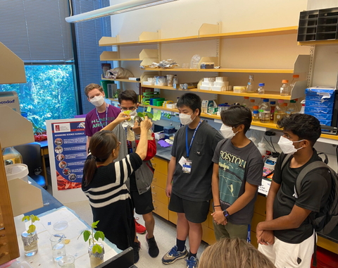 Huiqiao Pan talks to students about soybeans for a BioEYES outreach activity