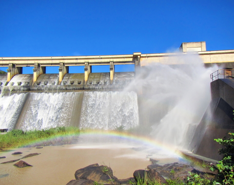Rainbow in front of a dam wall. Shot in Hazelmere Dam Nature Reserve, near Durban, North Coast of Kwazulu-Natal, South Africa.