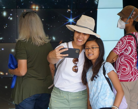 Visitors take a selfie in front of the VizLab at the Carnegie Observatories Open House, 2022
