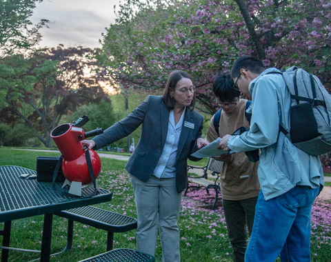 ALycia Weinberger uses a table top telescope