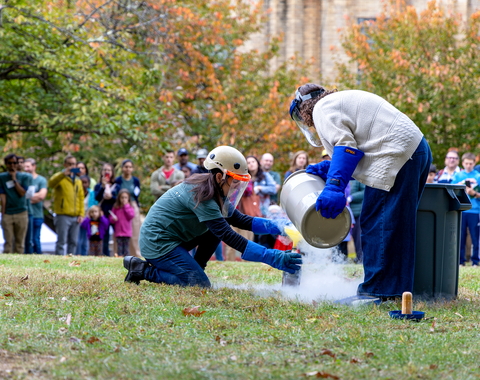 Diana Roman and Andrea Goltz prepare a "trash-cano" at the Earth & Planets Laboratory Open House.