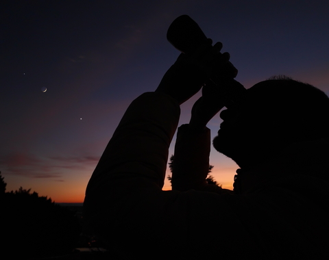 Stargazing with binoculars at sunset