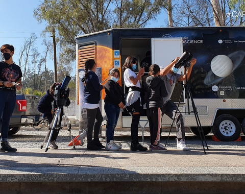 Students peer through a telescope when LabMovile comes to town.