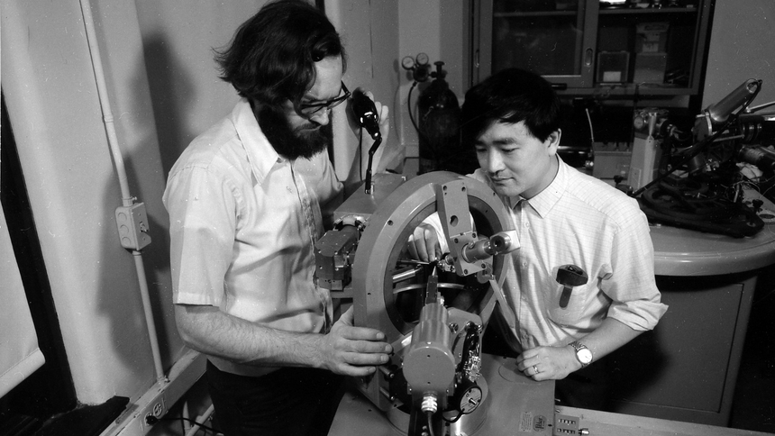 Larry Finger and Y. Ohashi aligning a crystal on the four-circle X-ray diffractometer in preparation for determining its structure