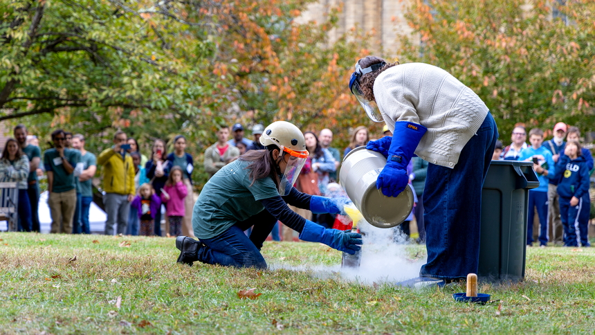 Diana Roman and Andrea Goltz prepare a "trash-cano" at the Earth & Planets Laboratory Open House.