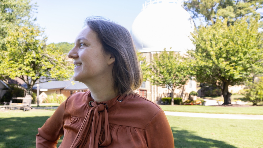Marion Le Voyer looks to the left in front of the Atomic Physics Observatory