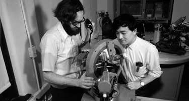 Larry Finger and Y. Ohashi aligning a crystal on the four-circle X-ray diffractometer in preparation for determining its structure