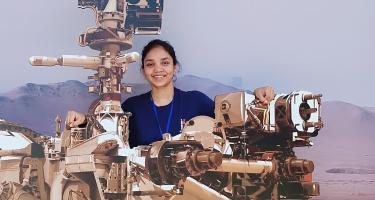 Anushree Srivastava poses with Mars rover mock ups