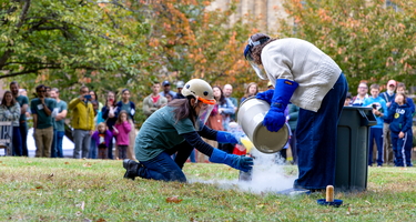 Diana Roman and Andrea Goltz prepare a "trash-cano" at the Earth & Planets Laboratory Open House.