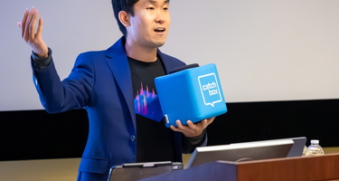 Mike Wong moderates Q&A at Neighborhood Lecture featuring NASA’s Caleb Scharf. In 2025, Wong and Scharf received a $5 million, five-year grant to develop A.I. tools for enhancing the search for signs of life on other planets.