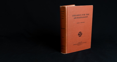 Red book on black backdrop. "Ceramics for the archaeologist"