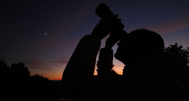 Stargazing with binoculars at sunset