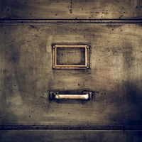 the front of an old file cabinet without a paper label in the metal frame