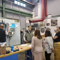 A tour group visits the Observatories machine shop