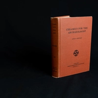 Red book on black backdrop. "Ceramics for the archaeologist"