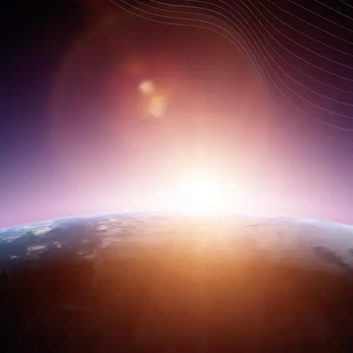 A star rises behind a planet, illuminating the planet's atmosphere.