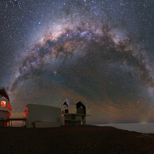 Stunning arc of the Milky Way taken with a fisheye lens, with an observational tower in the foreground