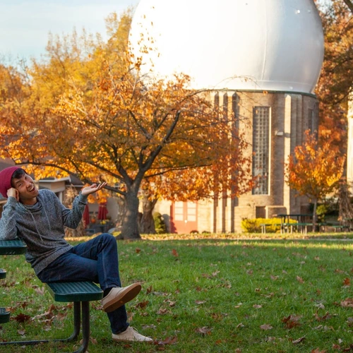 Mike Wong poses in front of the campus’ iconic Atomic Physics Observatory. 